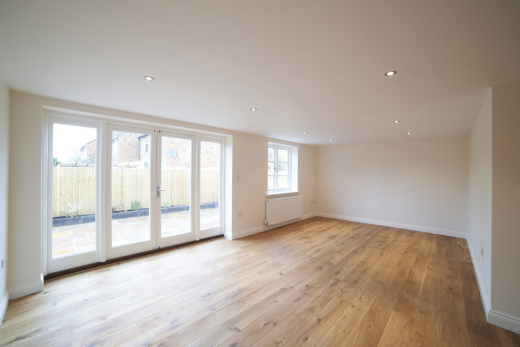 Living room with atrium doors leading to a Maryland backyard, installed by Quality Window & Door